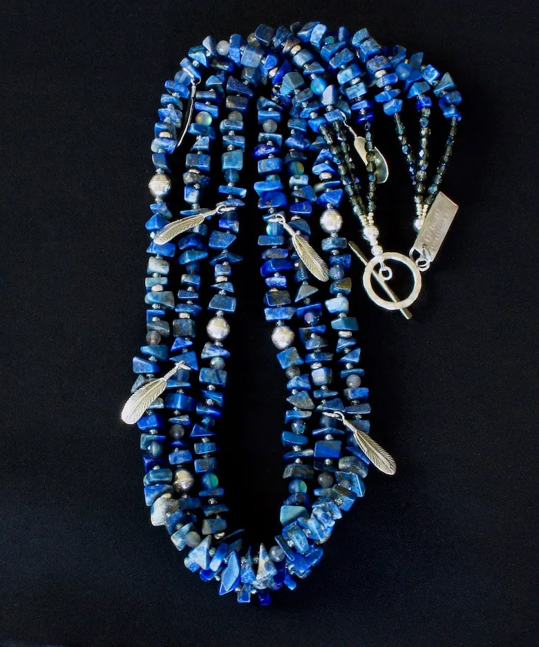 Lapis Lazuli Nugget 3-Strand Necklace with Bench-Made Sterling Silver Rounds, Sterling Silver Feather Charms, Translucent Blue Crystal Rounds, Labradorite Faceted Rounds, Fire Polished Glass, and Hammered Sterling Silver Toggle Clasp